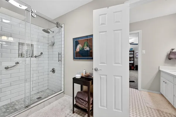 a bathroom with a walk in shower and a bathroom