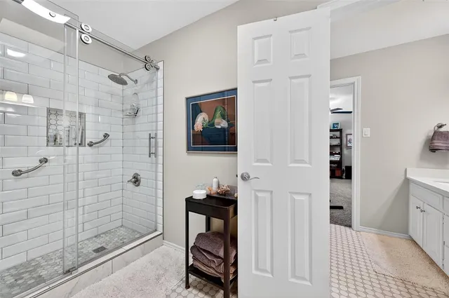 a bathroom with a walk in shower and a bathroom
