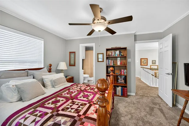 a bedroom with a bed furniture and a book shelf