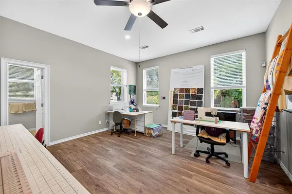 a view of a workspace with furniture and a window