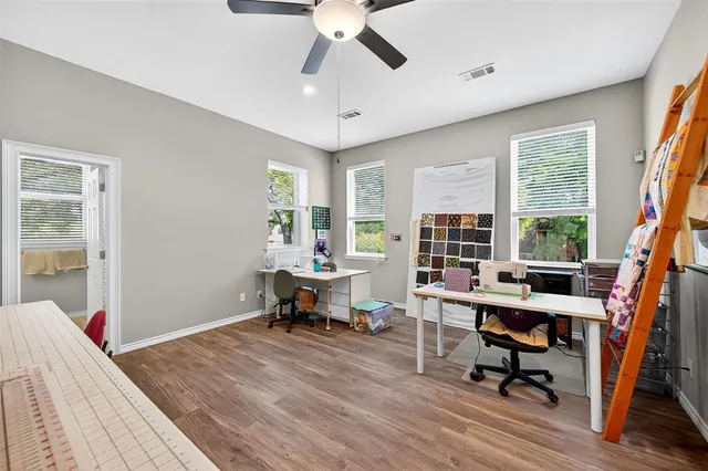 a view of a workspace with furniture and a window