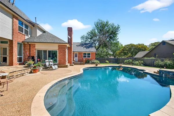 a view of a house with swimming pool and sitting area