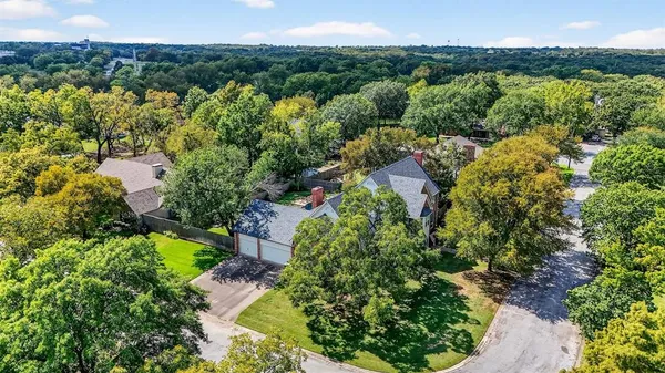 a view of a garden with a building in the background