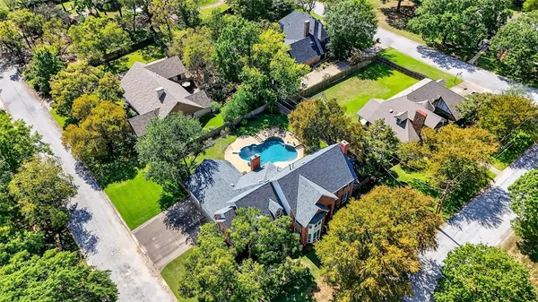 an aerial view of a house with a garden and swimming pool
