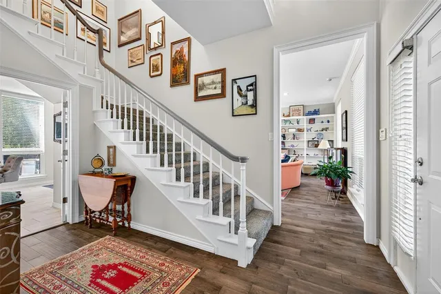 a view of entryway with wooden floor and stairs