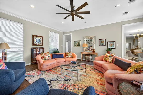 a living room with furniture a rug and a chandelier
