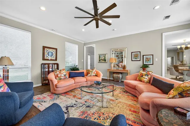 a living room with furniture a rug and a chandelier