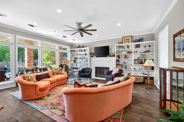 a living room with fireplace furniture and a flat screen tv