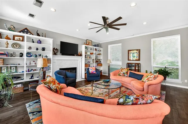 a living room with furniture a flat screen tv and a fireplace