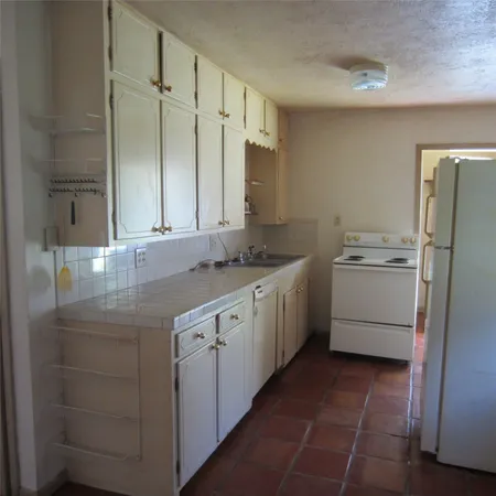 a utility room with cabinets washer and dryer