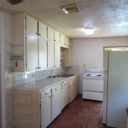 a kitchen with a sink and stove