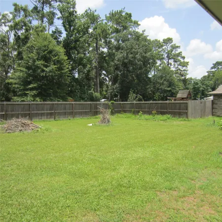 a view of a swimming pool with a yard