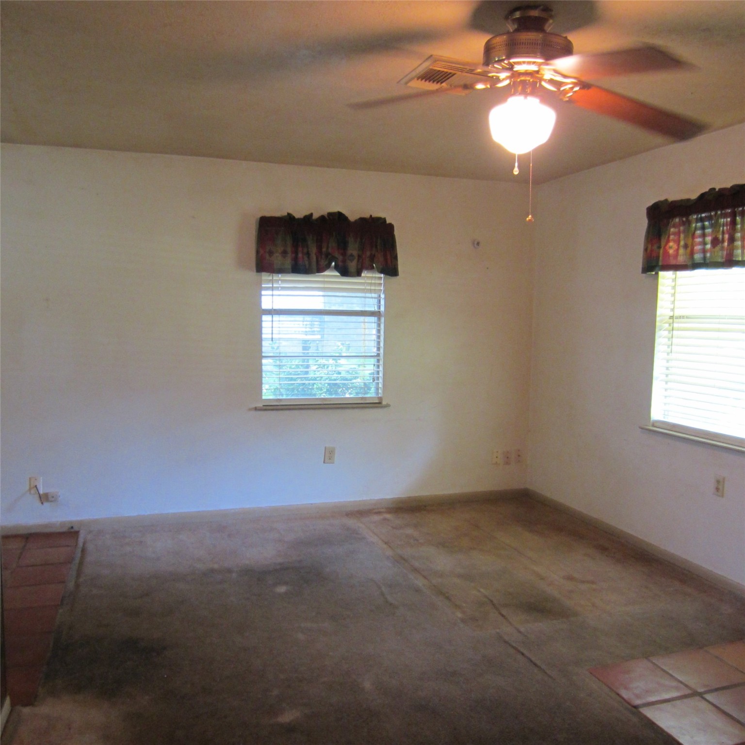 14758 Lucas Drive Splendora, TX 77372 - Photo 19 of 36 an empty room with windows and chandelier fan