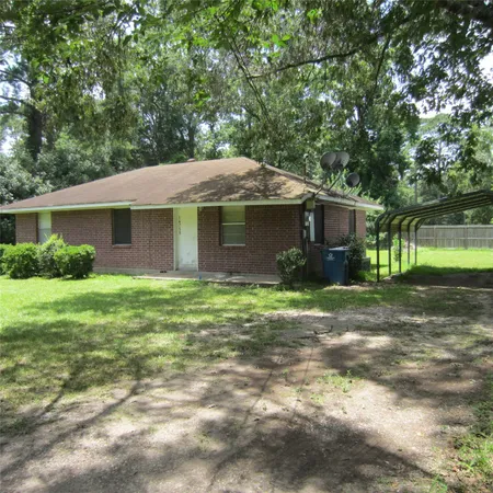 a front view of house with a garden