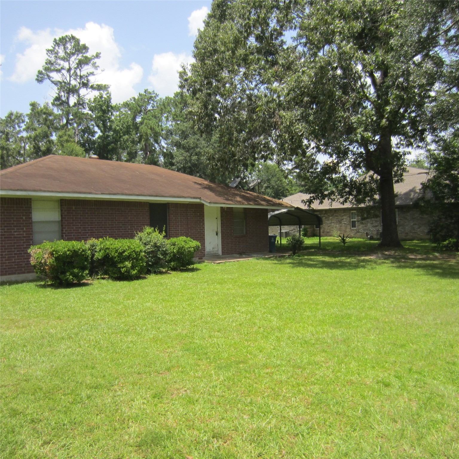 14758 Lucas Drive Splendora, TX 77372 - Photo 35 of 36 a front view of a house with a garden