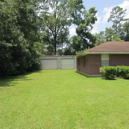 a front view of house with yard and trees