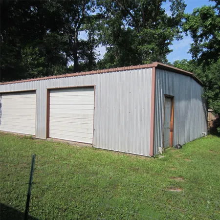 a view of backyard with cabin and wooden fence