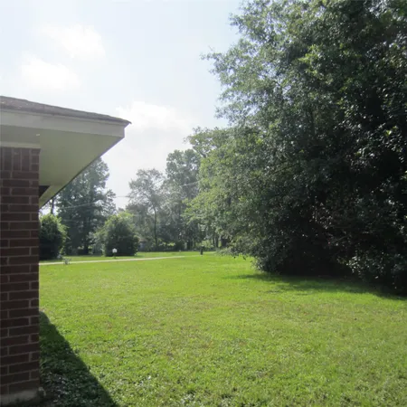 a view of a field with an trees in the background