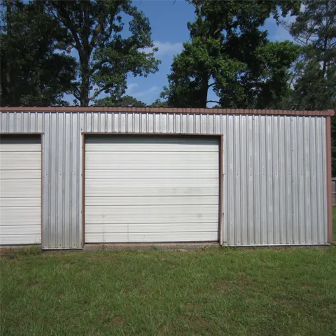 a view of backyard with cabin and wooden fence