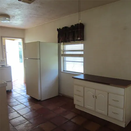 a kitchen with a refrigerator and window