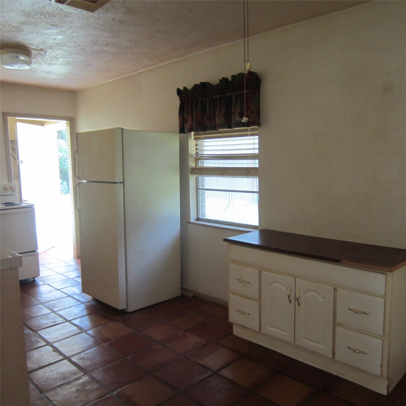 14758 Lucas Drive Splendora, TX 77372 - Photo 10 of 36 a kitchen with a refrigerator and window