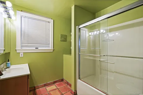 a bathroom with a shower and a sink