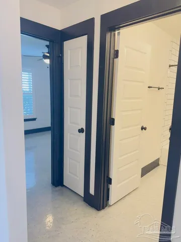 a bathroom with a granite countertop toilet sink and mirror