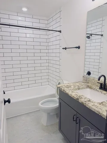 an empty room with a window and a ceiling fan