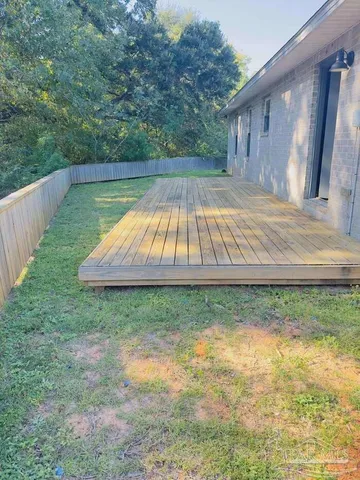 a view of a house with a yard and a large pool
