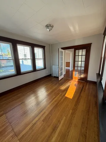wooden floor in an empty room with a window