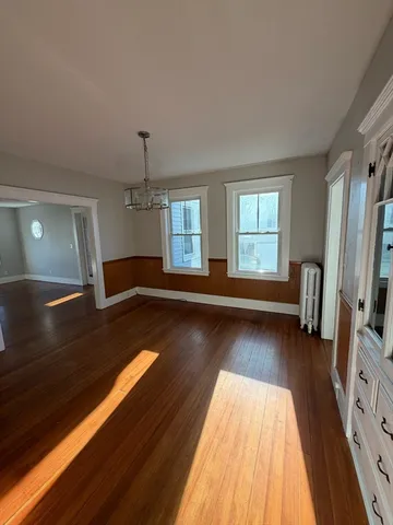 a view of dining room with wooden floor and fan