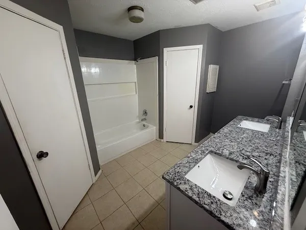 a bathroom with a sink and mirror