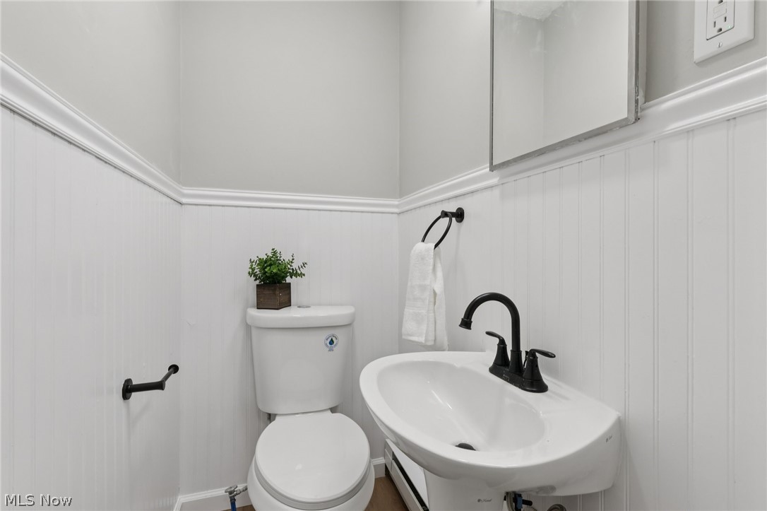 7412 Hopkins Road Mentor, OH 44060 - Photo 28 of 36 Bathroom with wainscoting and a baseboard radiator