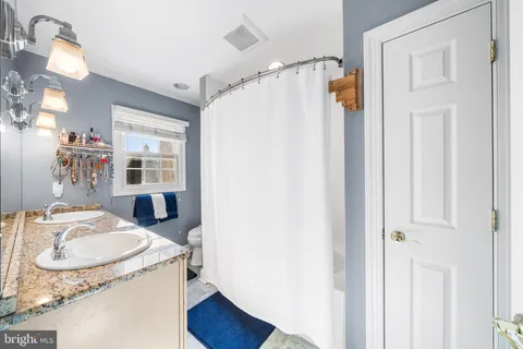 a bathroom with a sink double vanity and a mirror