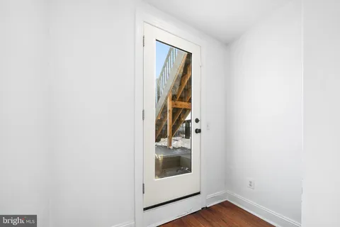 a view of an entryway with wooden floor