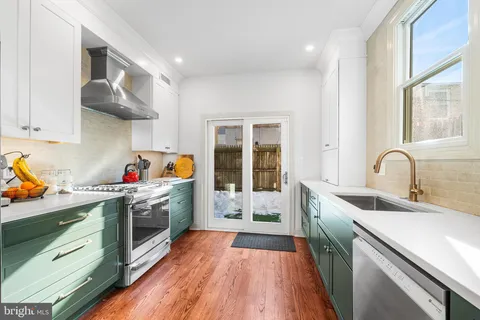 a kitchen that has a sink and a stove in it
