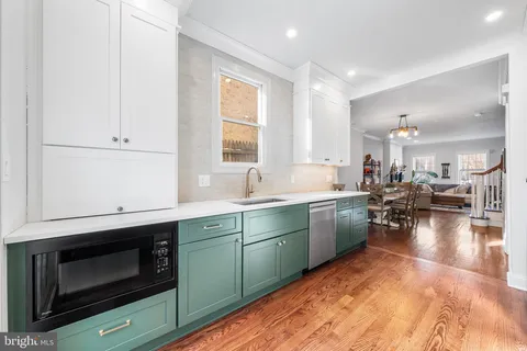 a kitchen with a sink cabinets and window