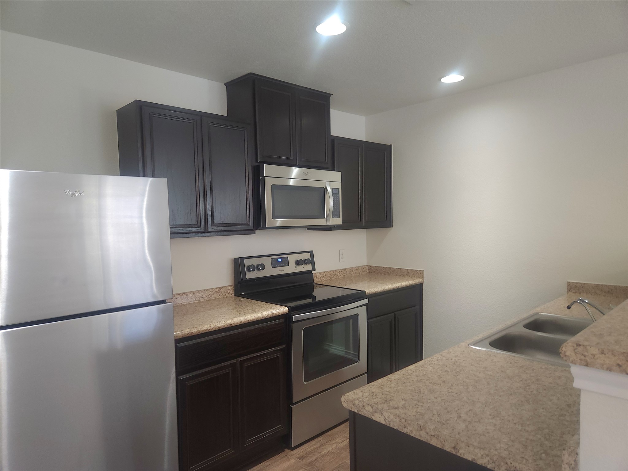160 Rummel Drive Kyle, TX 78640 - Photo 4 of 13 A compact culinary space features modern stainless steel appliances and ample counter area.