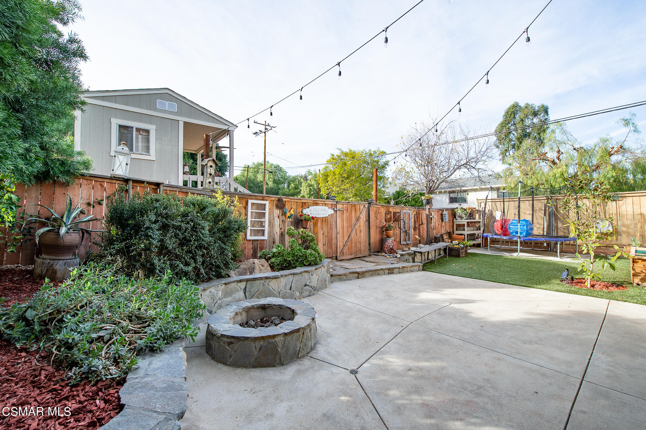 167 Brook Road Newbury Park, CA 91320 - Photo 23 of 30 a backyard of a house with table and chairs potted plants