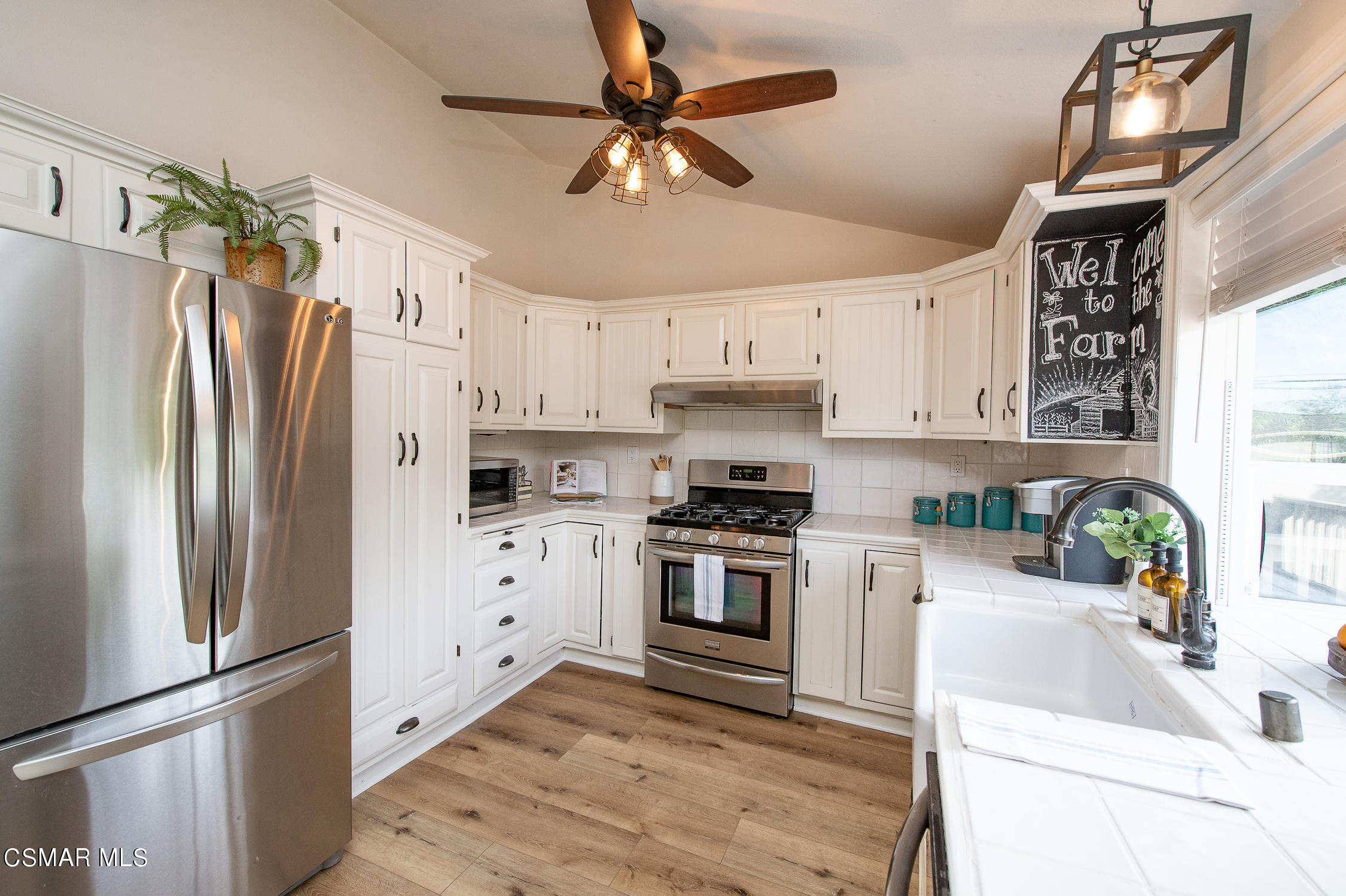167 Brook Road Newbury Park, CA 91320 - Photo 10 of 30 a kitchen with white cabinets and stainless steel appliances