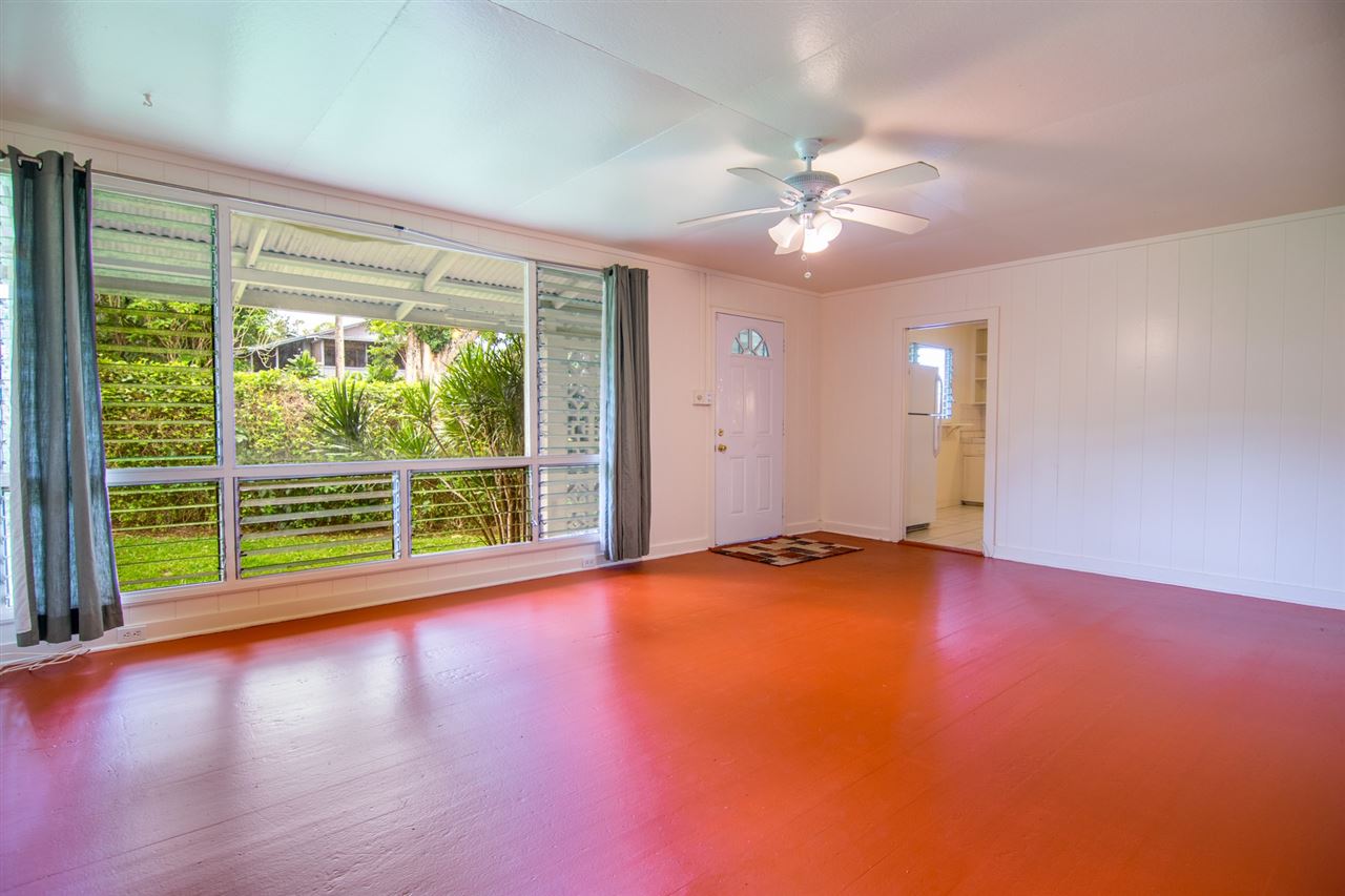 1631 Haiku Road Haiku, HI 96708 - Photo 4 of 24 a view of an empty room with window and wooden floor