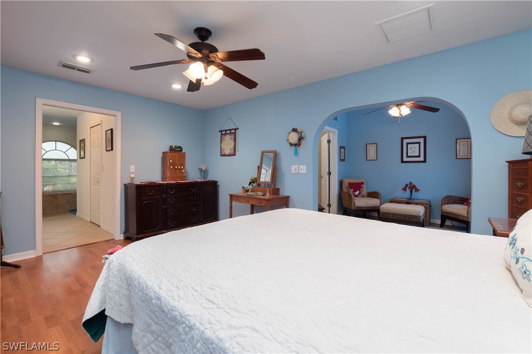 9115 Irving Road Fort Myers, FL 33967 - Photo 14 of 35 a bed room with a bed and a chandelier