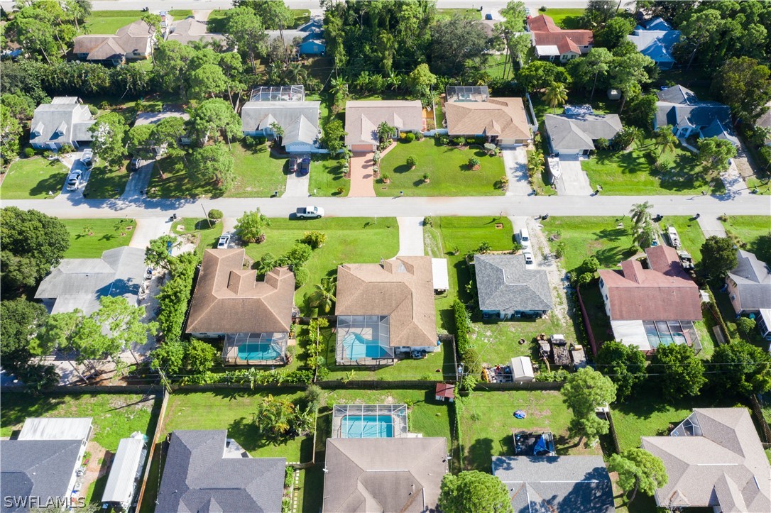 9115 Irving Road Fort Myers, FL 33967 - Photo 34 of 35 an aerial view of multiple houses with yard