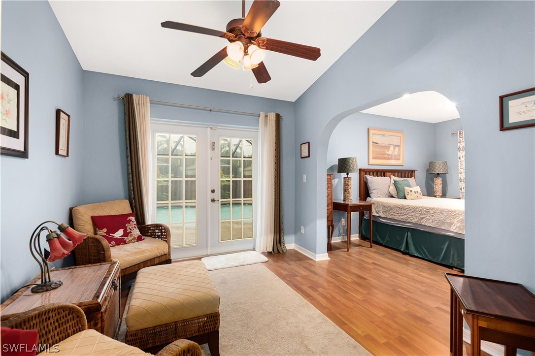 9115 Irving Road Fort Myers, FL 33967 - Photo 9 of 35 a bedroom with a bed and a chandelier