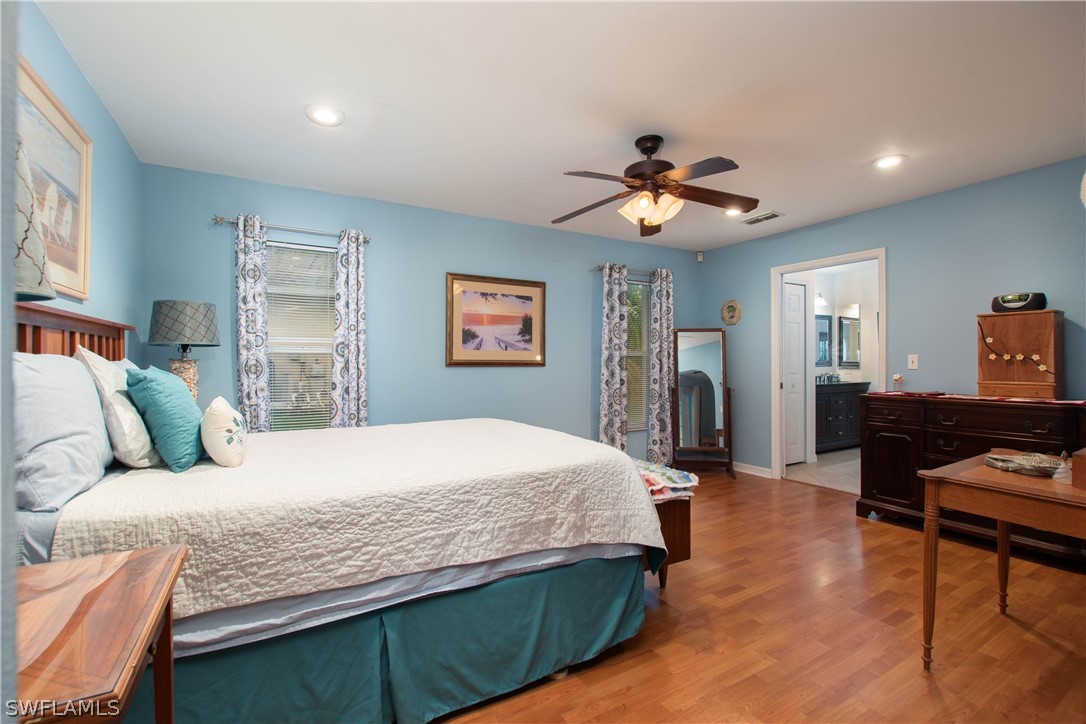 9115 Irving Road Fort Myers, FL 33967 - Photo 10 of 35 a bedroom with a bed and wooden floor