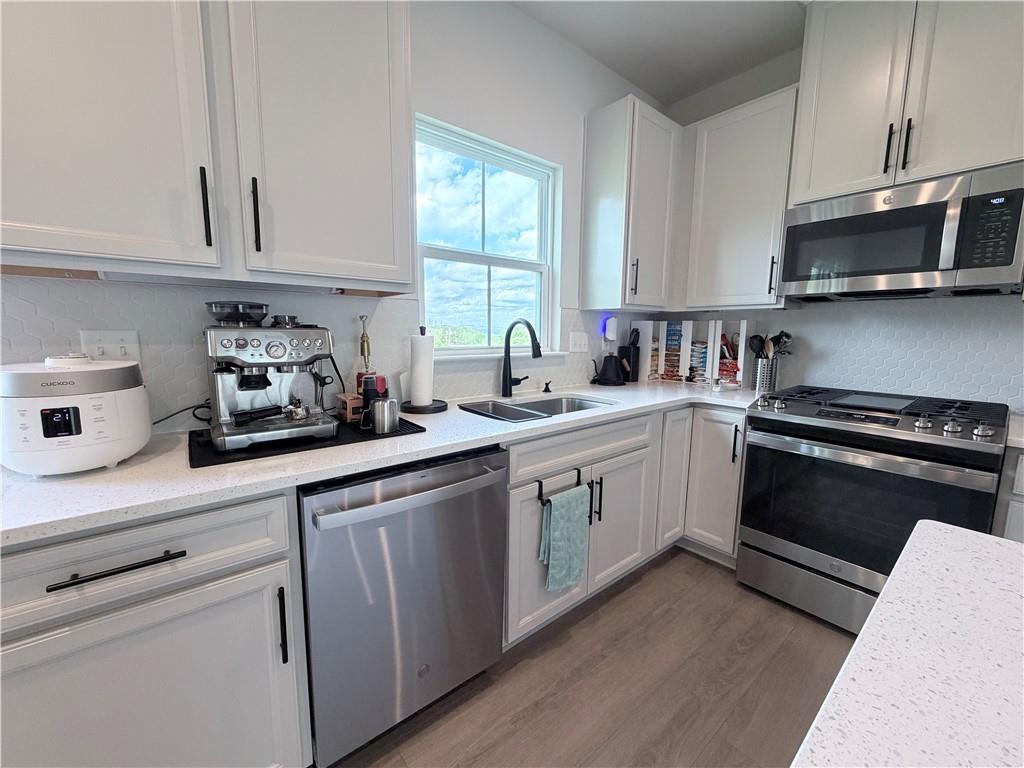 120 Crown Street McKees Rocks, PA 15136 - Photo 8 of 28 a kitchen with a sink stove and microwave