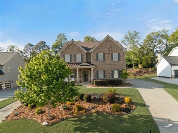 a front view of a house with a yard and garage