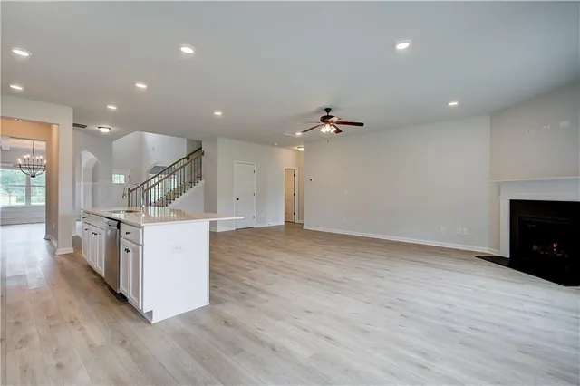 a view of kitchen and hall with wooden floor