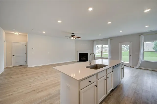 a kitchen with sink and refrigerator