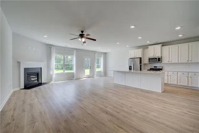 a view of kitchen with granite countertop cabinets and wooden floor